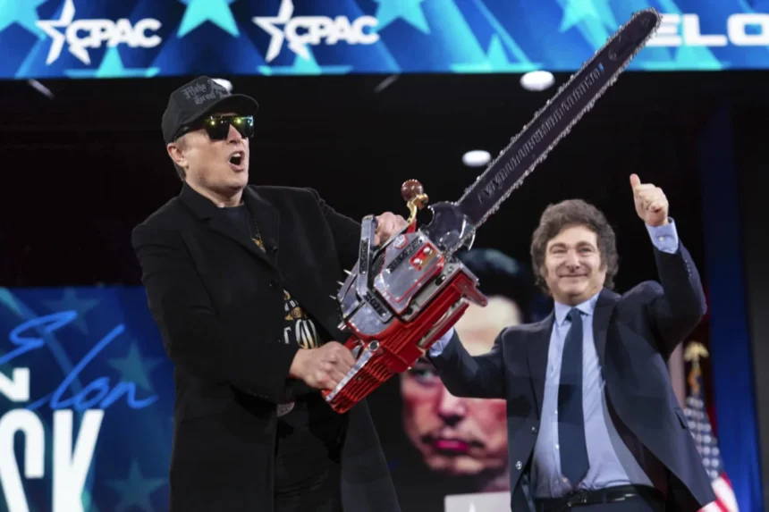 Elon Musk wields a futuristic chainsaw on stage at CPAC alongside Javier Milei, symbolizing bold, controversial moves amid reports of 21 tech employees quitting Musk’s DOGE over critical security concerns.