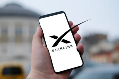 Hand holding a smartphone with the Starlink logo on the screen, illustrating SpaceX’s satellite internet service