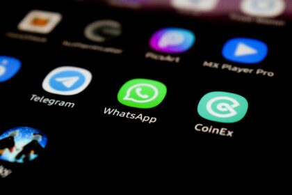 WhatsApp app icon on a smartphone screen alongside Telegram and other apps.