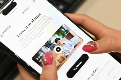 Close-up of a smartphone displaying the Manus AI website, a Chinese AI assistant designed to perform human-like complex tasks