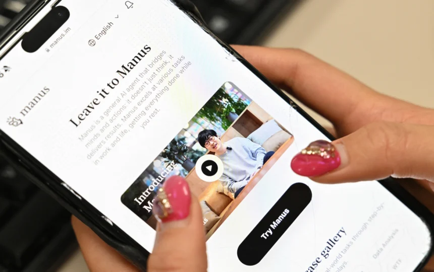 Close-up of a smartphone displaying the Manus AI website, a Chinese AI assistant designed to perform human-like complex tasks
