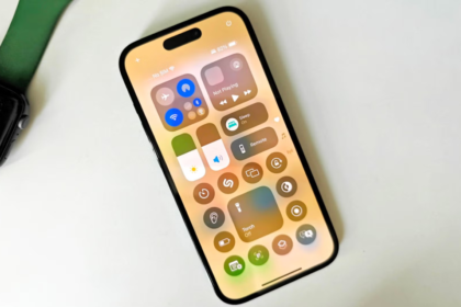 iPhone running iOS 18.4 showing Control Center with Apple Watch on desk