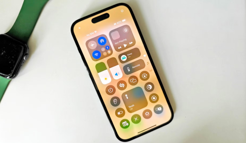iPhone running iOS 18.4 showing Control Center with Apple Watch on desk