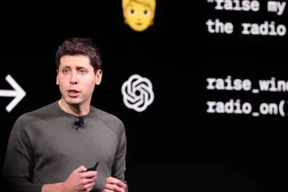 OpenAI CEO Sam Altman presenting a ChatGPT update on stage with AI-related visuals in the background.