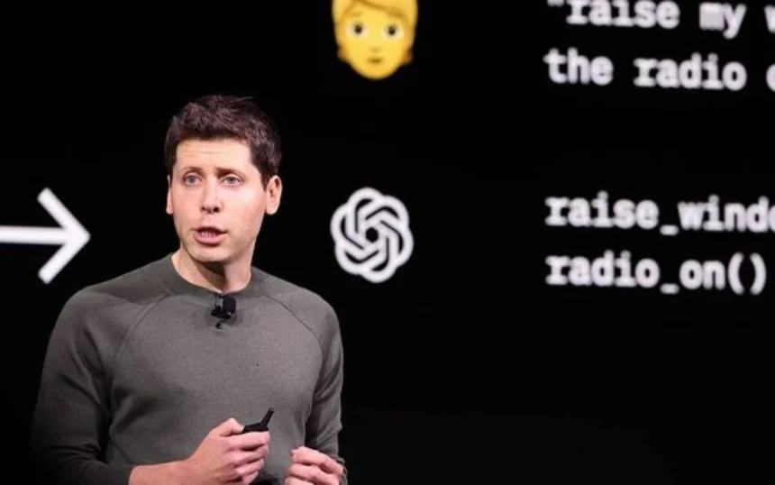 OpenAI CEO Sam Altman presenting a ChatGPT update on stage with AI-related visuals in the background.