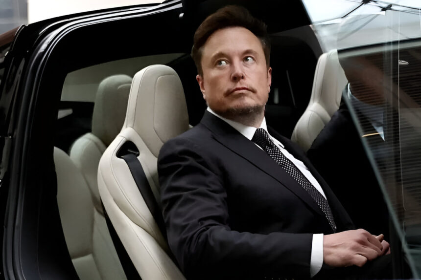Elon Musk seated in a Tesla electric car wearing a black suit, looking to the side. | Elon Musk Threatened to Deport Engineers Who Exposed Flaws in Tesla Cars: "He's Pure Evil"
