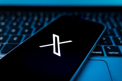 X social media platform logo on phone